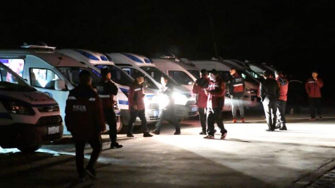 Emergency personnel and vehicles wait on standby at the Yellow River Stone Forest tourist site in Baiyin in northwestern China's Gansu Province,