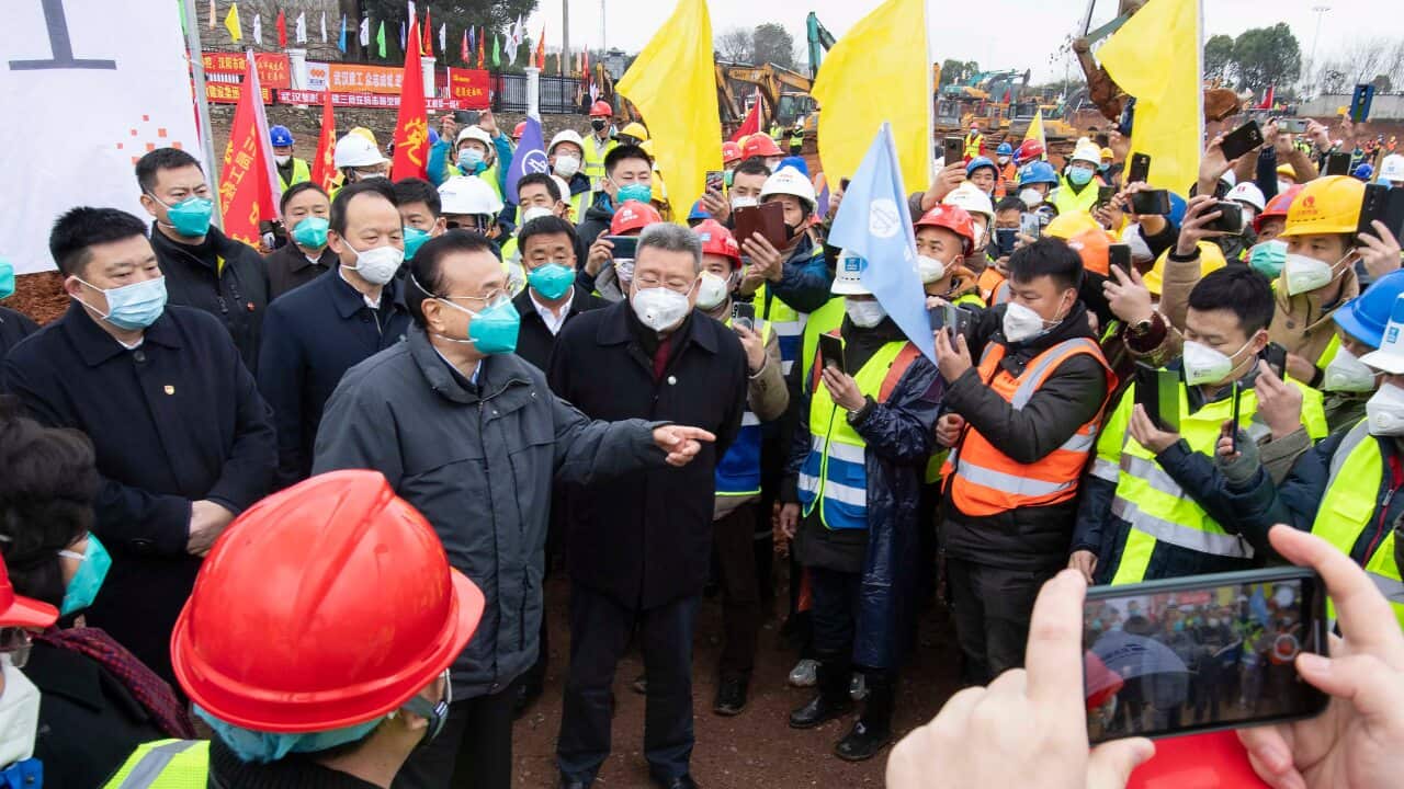 Chinese Premier Li Keqiang speaks with construction workers at the site of makeshift field hospital being built in Wuhan.