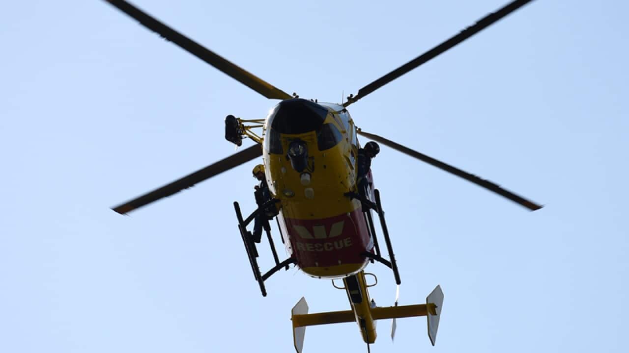 Paramedics arrive aboard a rescue helicopter