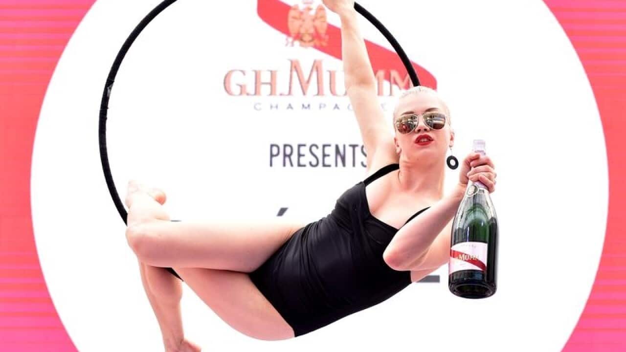 Performers are seen in Maison Mumm ahead of the Melbourne Cup Carnival