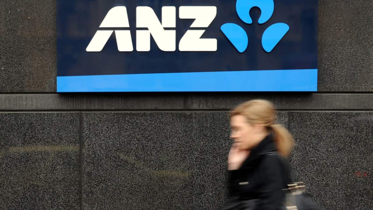 A woman walking past an ANZ automatic teller machine in Melbourne