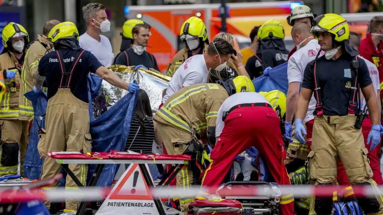 Rescue workers help an injured person after a car crashed into a crowd of people in central Berlin, Germany, on Wednesday.