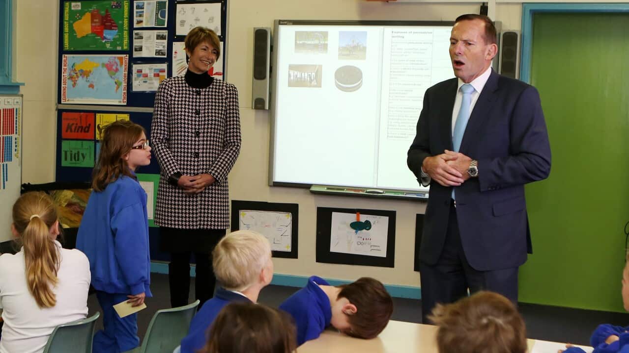 A child rests his head while the Tony Abbott talks