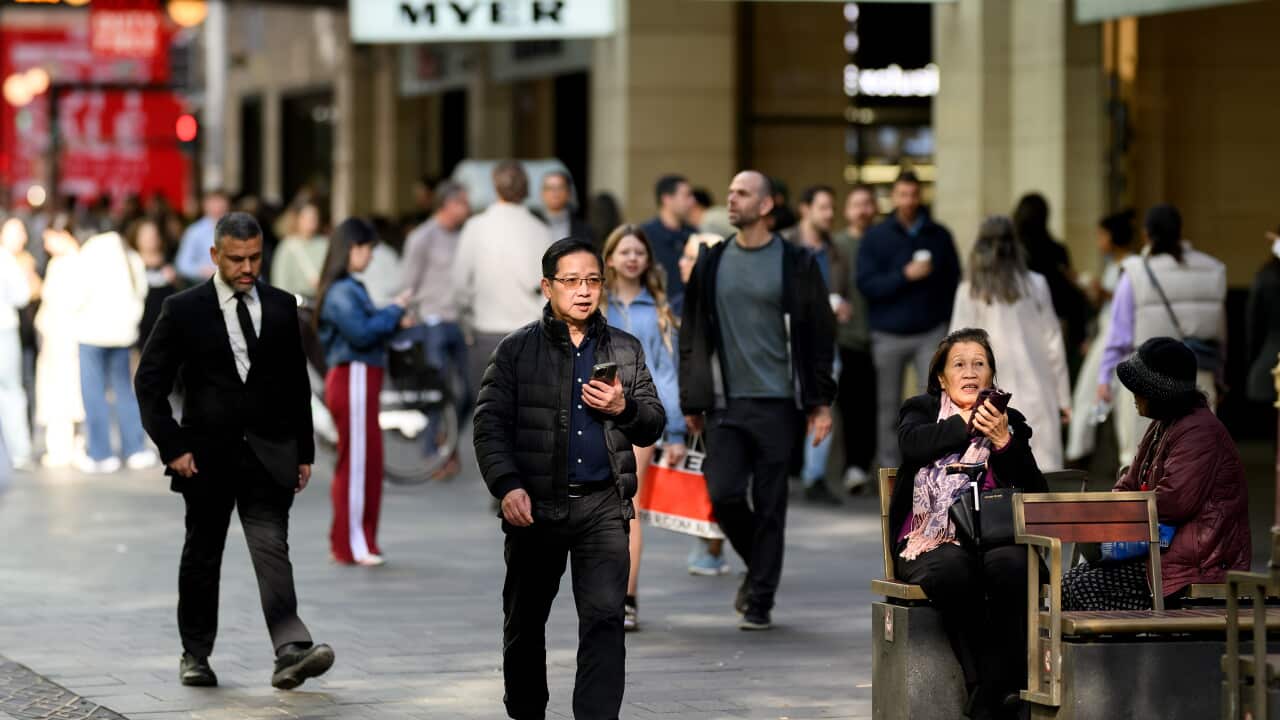 People walking in an outdoor shopping centre.