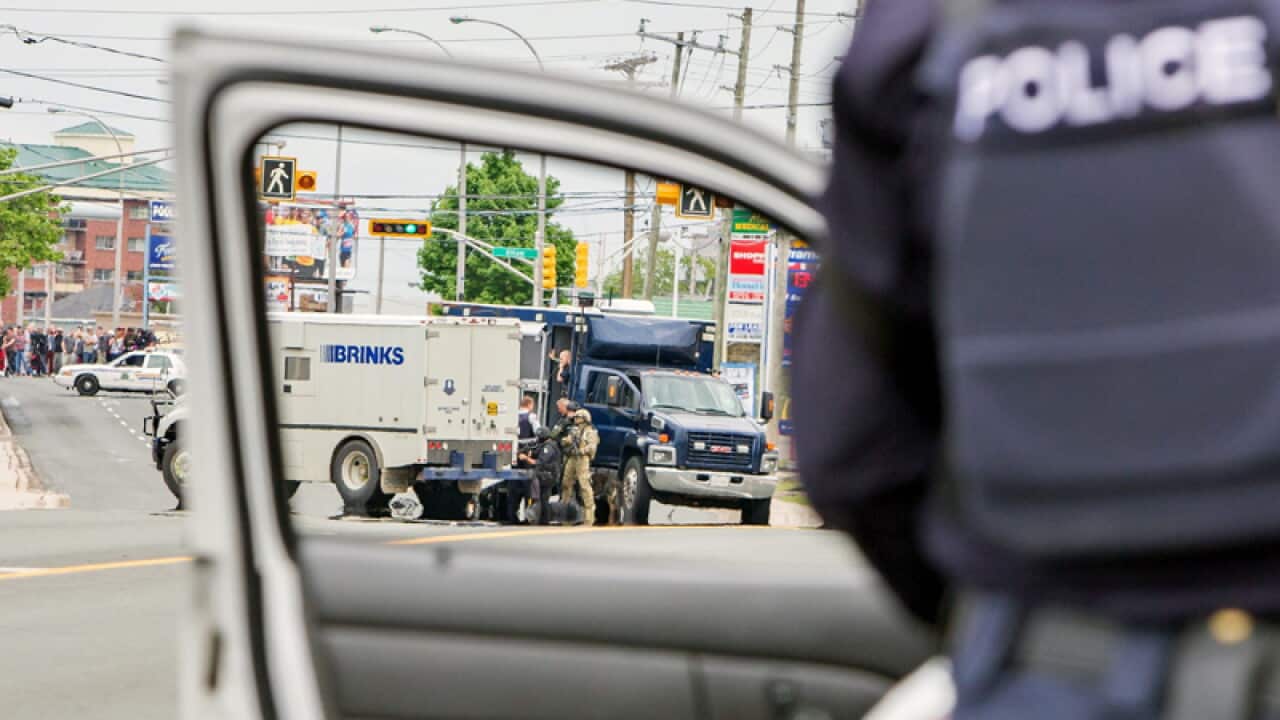 Police investigate a building in Moncton, New Brunswick
