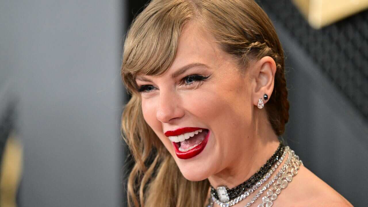 A close up of a woman smiling and posing for the camera.