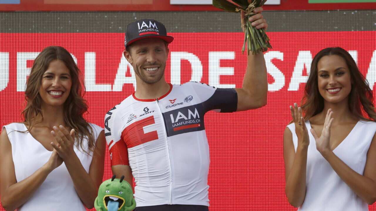 Belgian winner Jonas Van Genechten of IAM celebrates on the podium