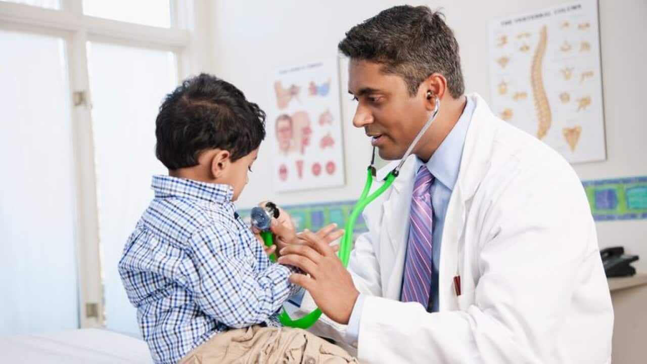 Doctor examining boy in doctor's office