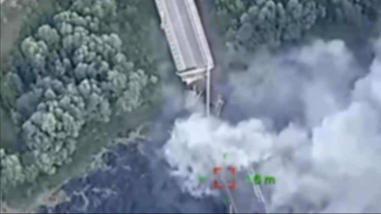 A blurry photo of a bridge being blown up