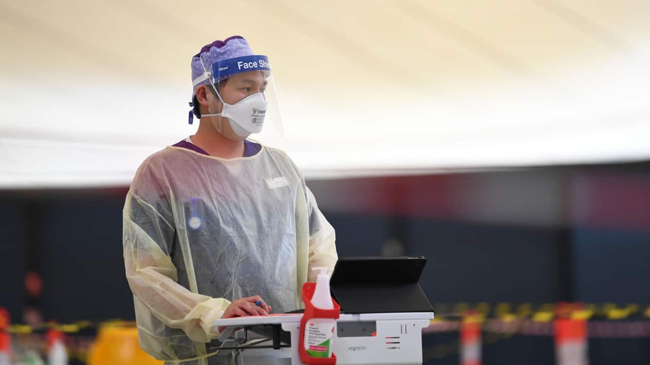 Helathcare worker Brandon Nguyen is seen working at a drive-through Covid19 testing facility in Melbourne, Friday, 8 October, 2021.