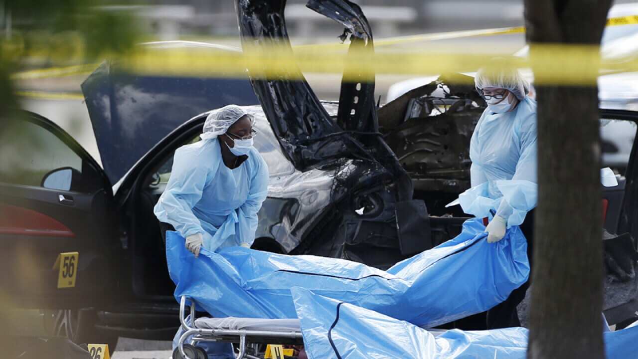 Personnel remove the bodies of two gunmen in Garland, Texas