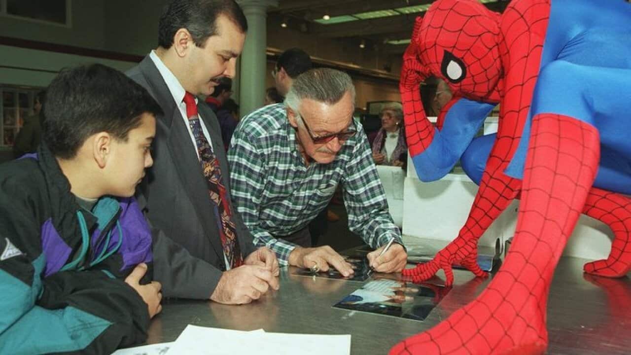 Stan Lee signing an autograph in 1995