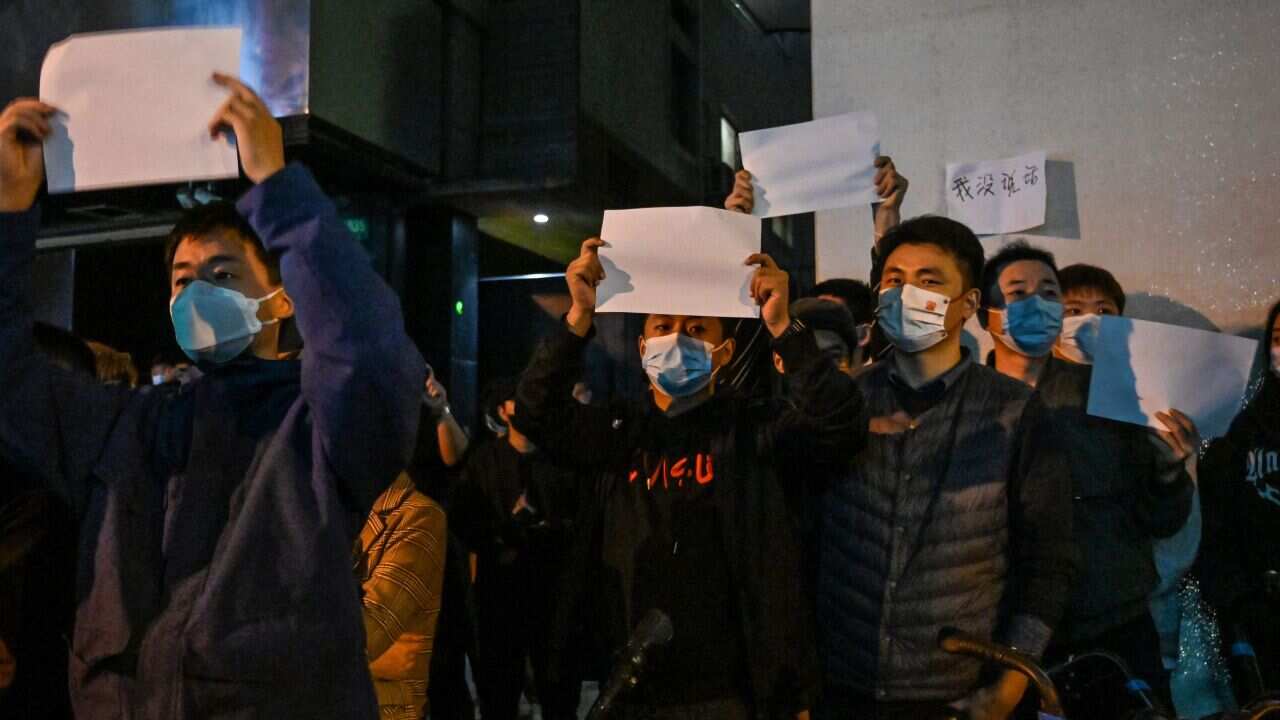 Protesters holding blank sheets of paper