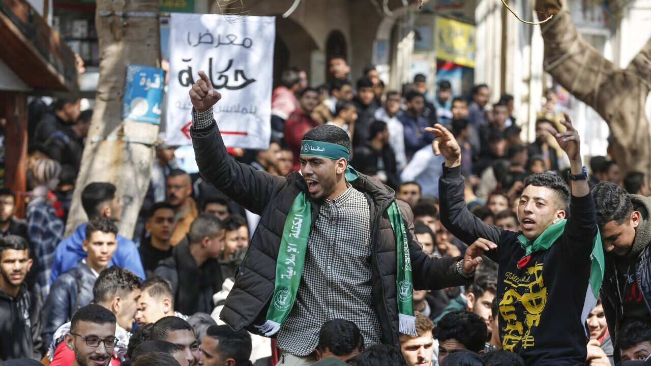 Palestinian youth chanting at a demonstration against the meeting in Jordan (AAP).jpg