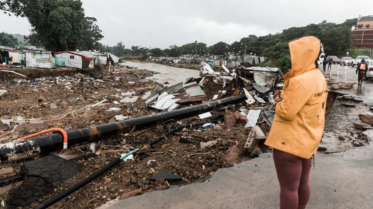 A woman looking at flood damage.
