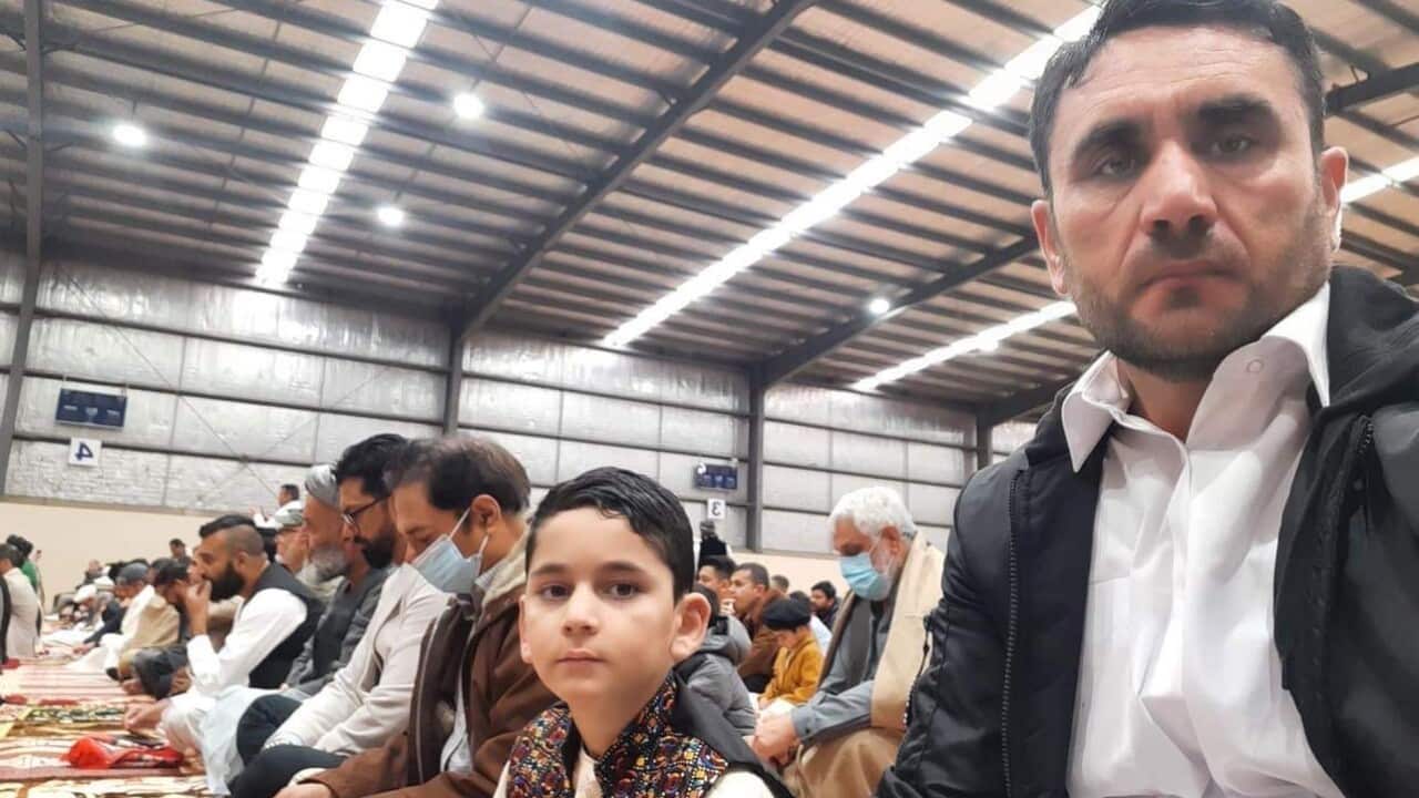 Sayed Wahdat Saddat with his son at Eid prayers in Melbourne.