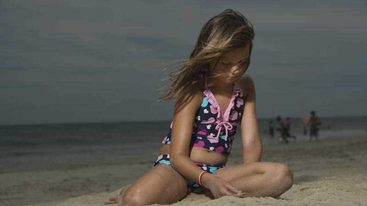 Little Girl Sitting on a Beach