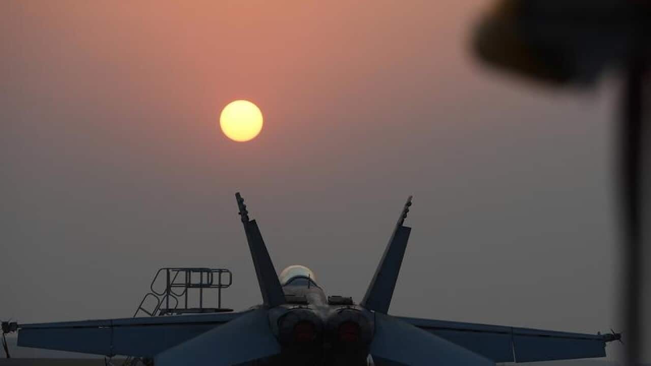 An Australian fighter jet under a sunset