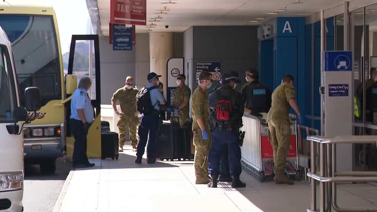 Officials guide returning travellers