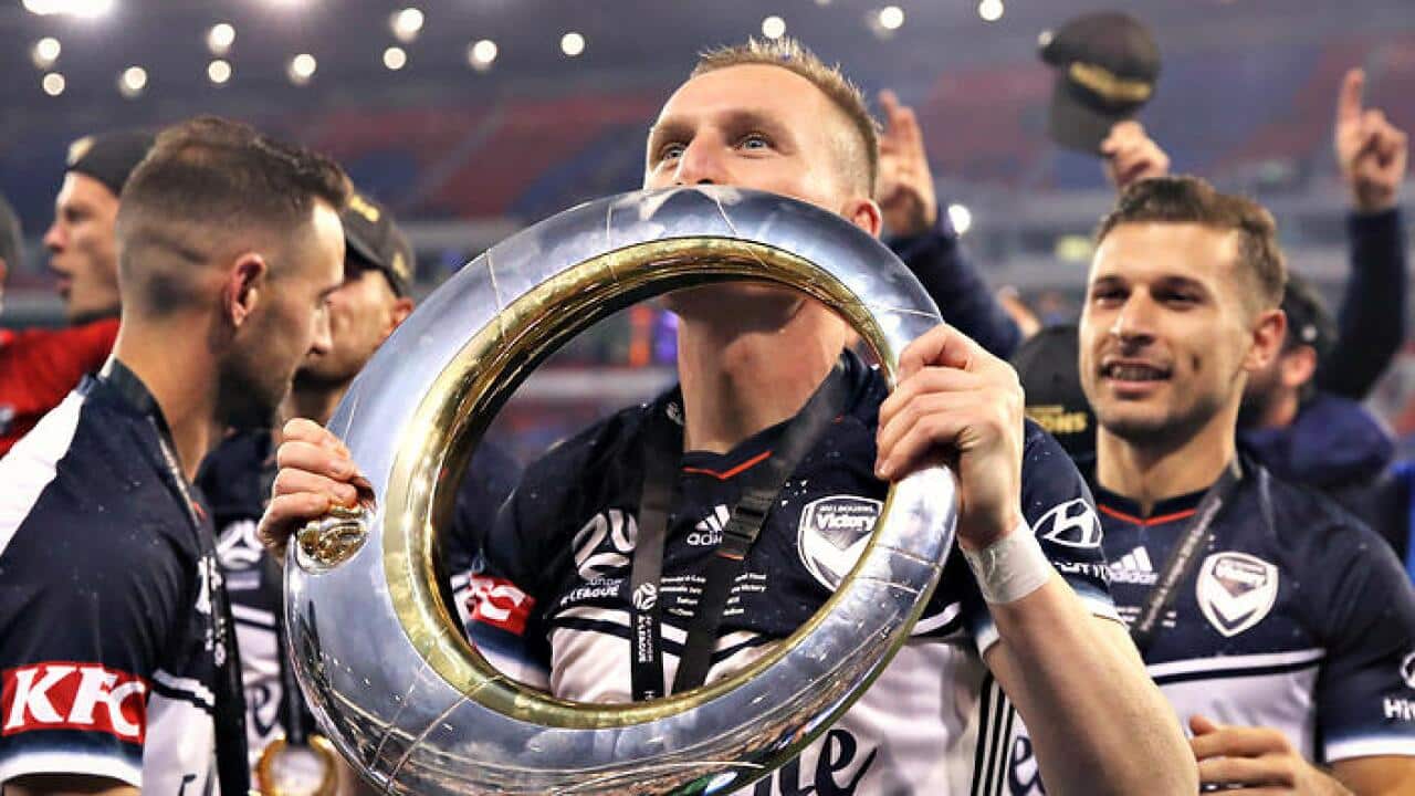 Victory players celebrate the grand final win