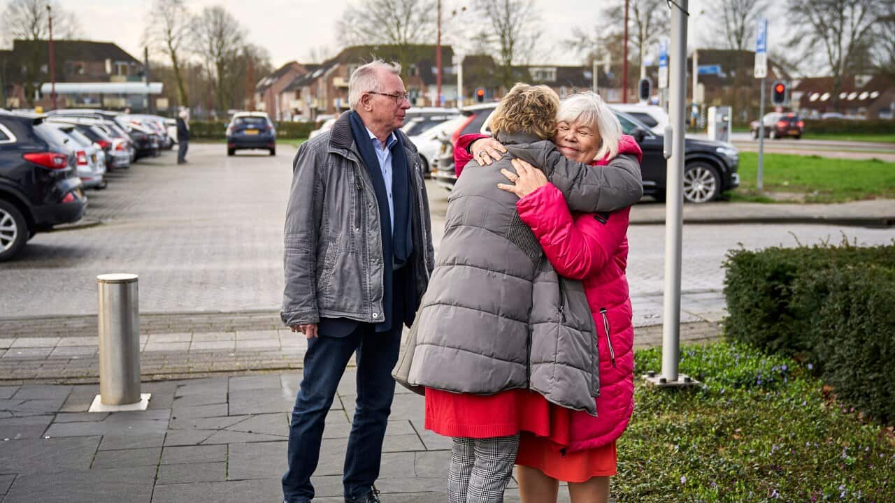 Relatives of victims of the Malaysia Airlines Flight 17 embrace as they arrive to watch a transmission of the court sessionat a congress center in Nieuwegein