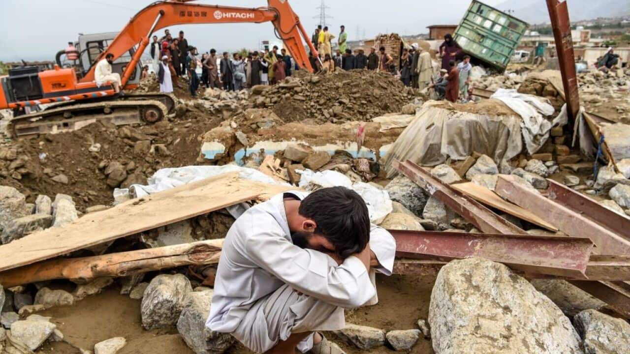 A village next to his destroyed house as rescuers search for survivors and bodies after a flash flood affected the area in Charikar.