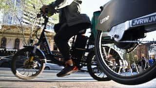 E-bikes seen from ground level on an urban street.
