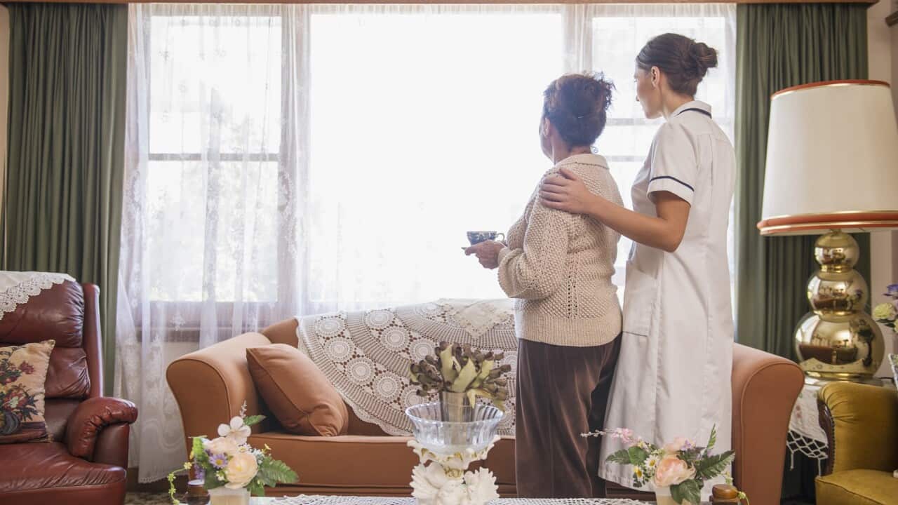 Hispanic nurse comforting senior woman