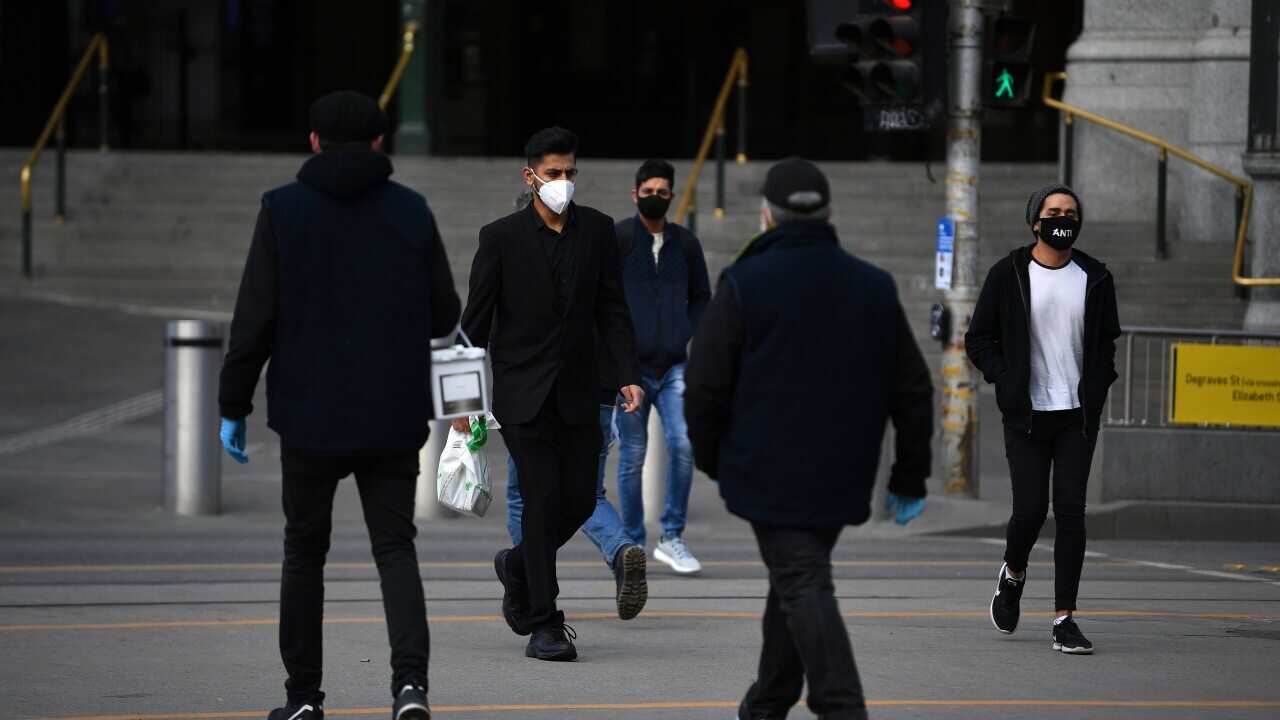 People are seen wearing face masks outside of Flinders Street Station in Melbourne, Thursday, July 23, 2020