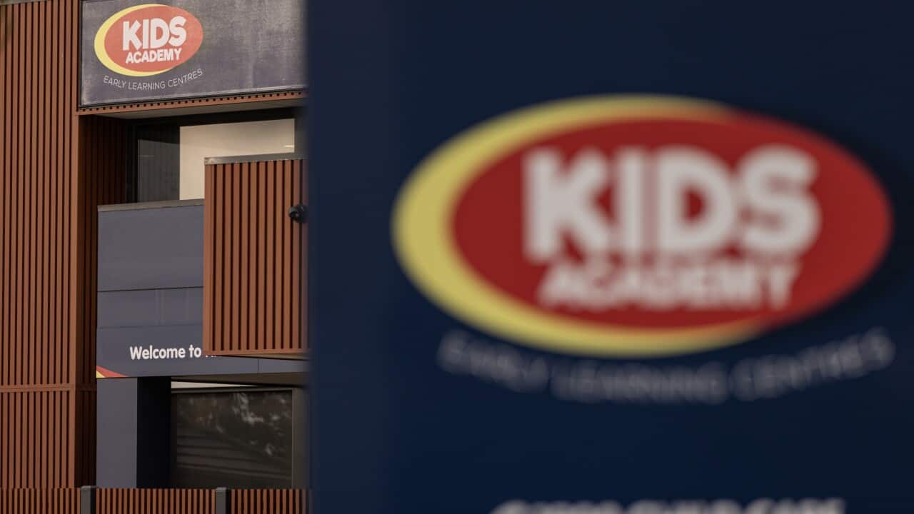 An entrance of a childcare centre with a red oval logo and the words "KIDS ACADEMY"