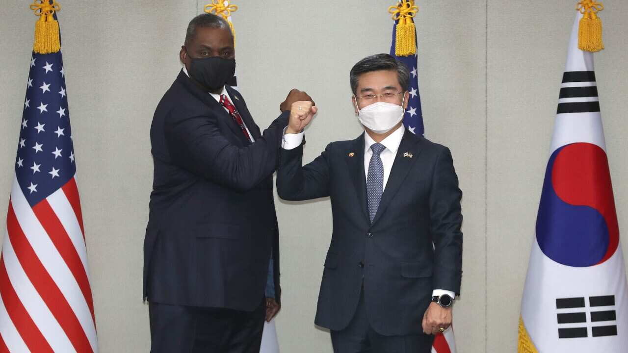 Defense Secretary Lloyd Austin, (L), poses with South Korean Defense Minister Suh Wook, during a meeting at the Defense Ministry in Seoul, South Korea on Mar