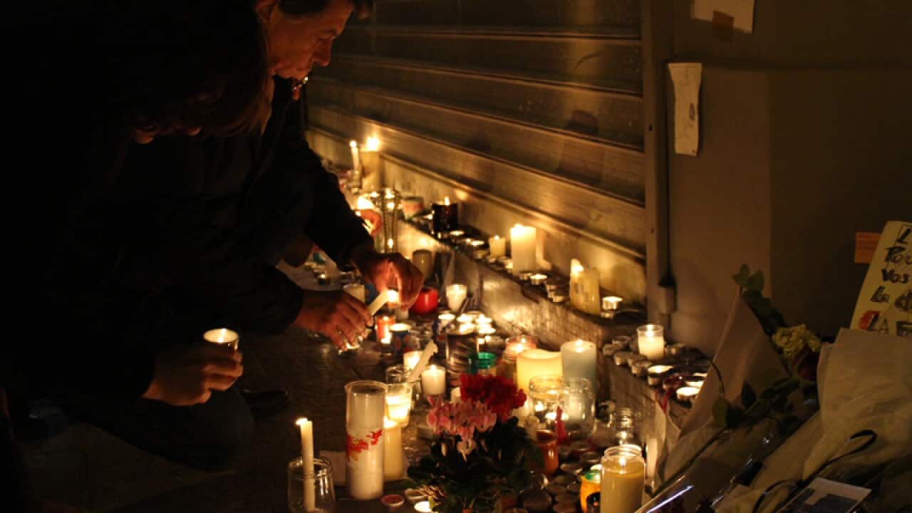Candles and tributes outside Le Petit Cambodge restaurant in Paris