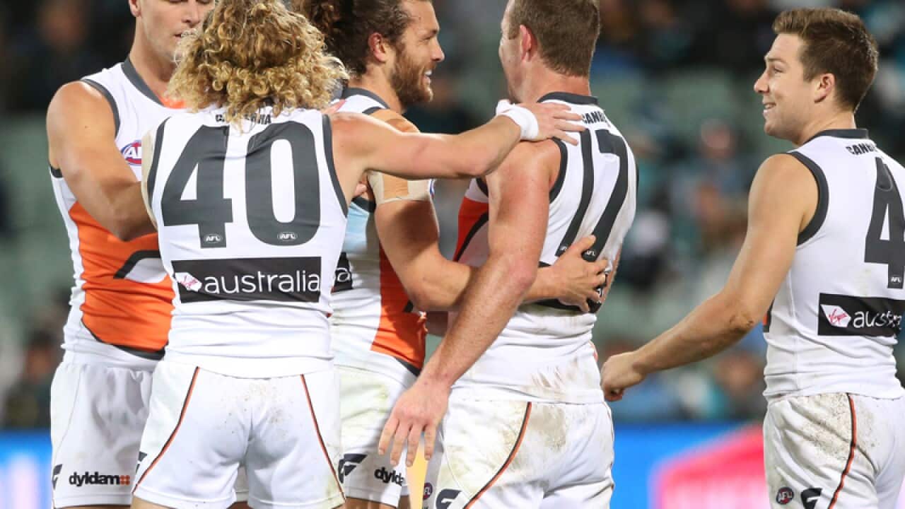 Sam Reid of the Giants is congratulated by team mates