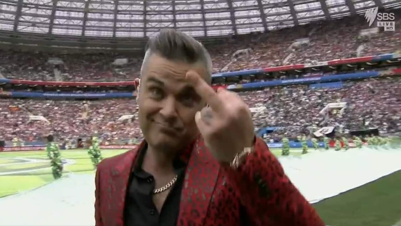 Robbie Williams signing off with an obscene hand gesture.