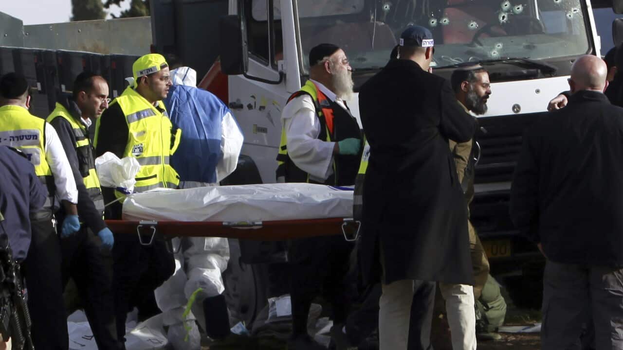 A body is being removed from the scene of an attack in Jerusalem Sunday, Jan. 8, 2017.