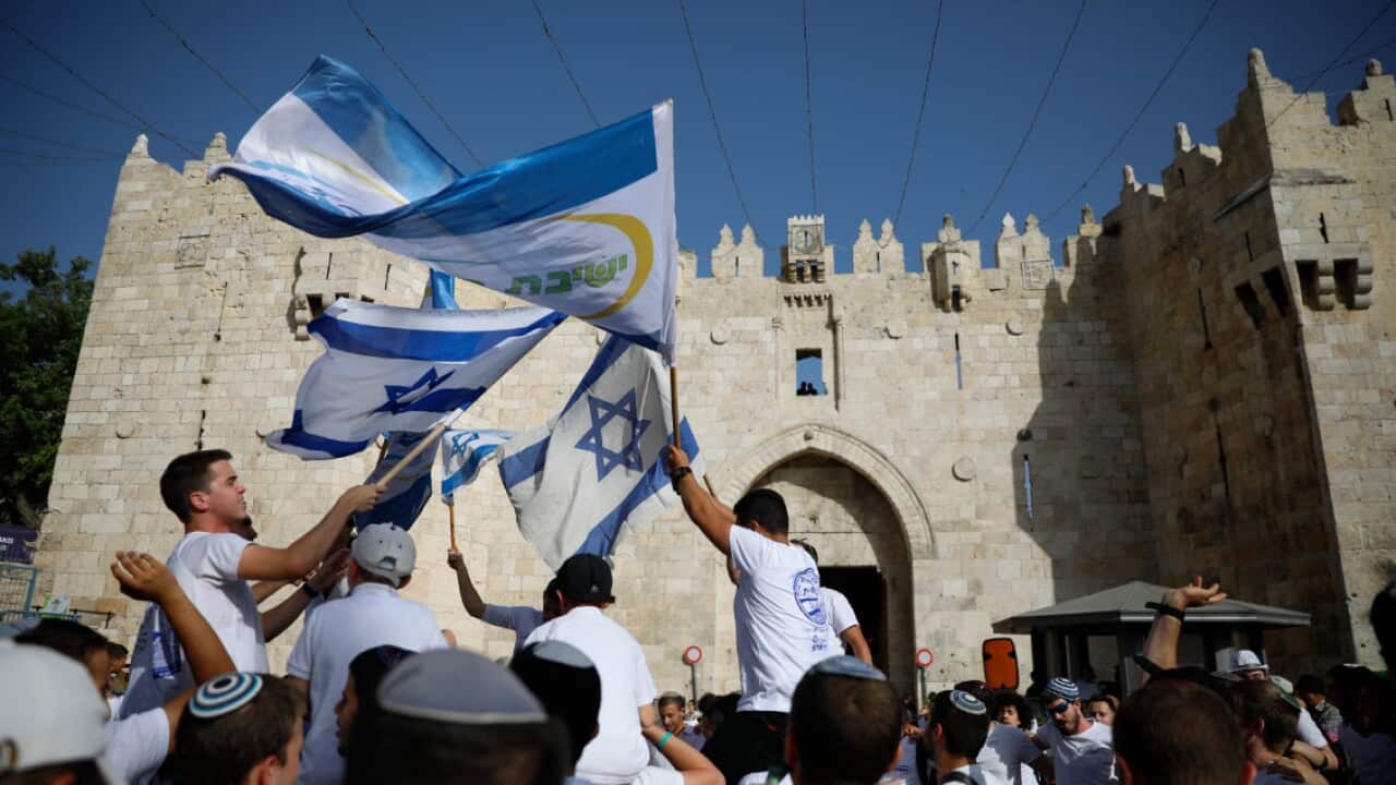 Israelis wave national flags tin front of he Damascus Gate of the Jerusalem's Old City Sunday, June 2, 2019, during Jerusalem Day (AAP)