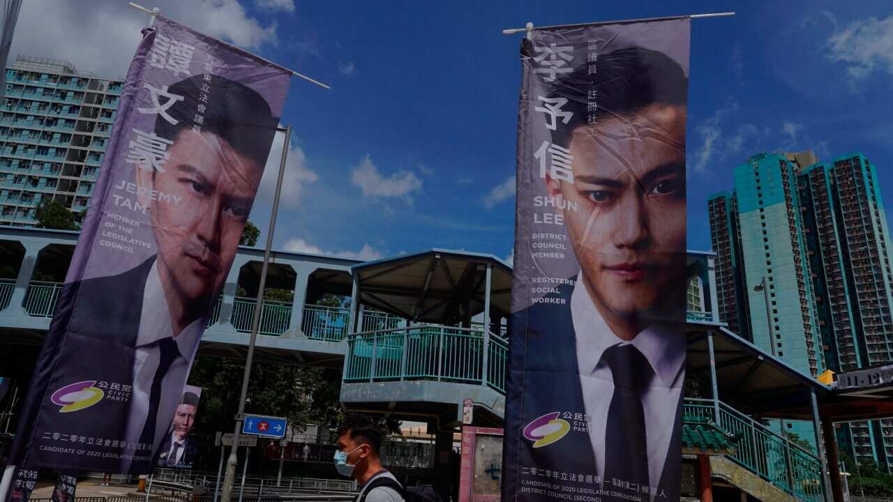 Banners of pro-democracy candidates are displayed outside a subway station in voting in Hong Kong.