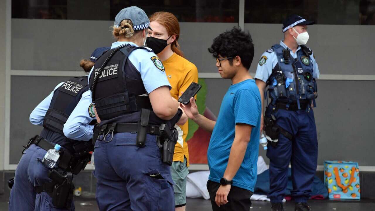 NSW police check identifications at George St in front of the Sydney Town Hall in anticipation of an anti-lockdown rally in Sydney Sydney, Saturday, July 31, 2021. (AAP Image/Mick Tsikas) NO ARCHIVING