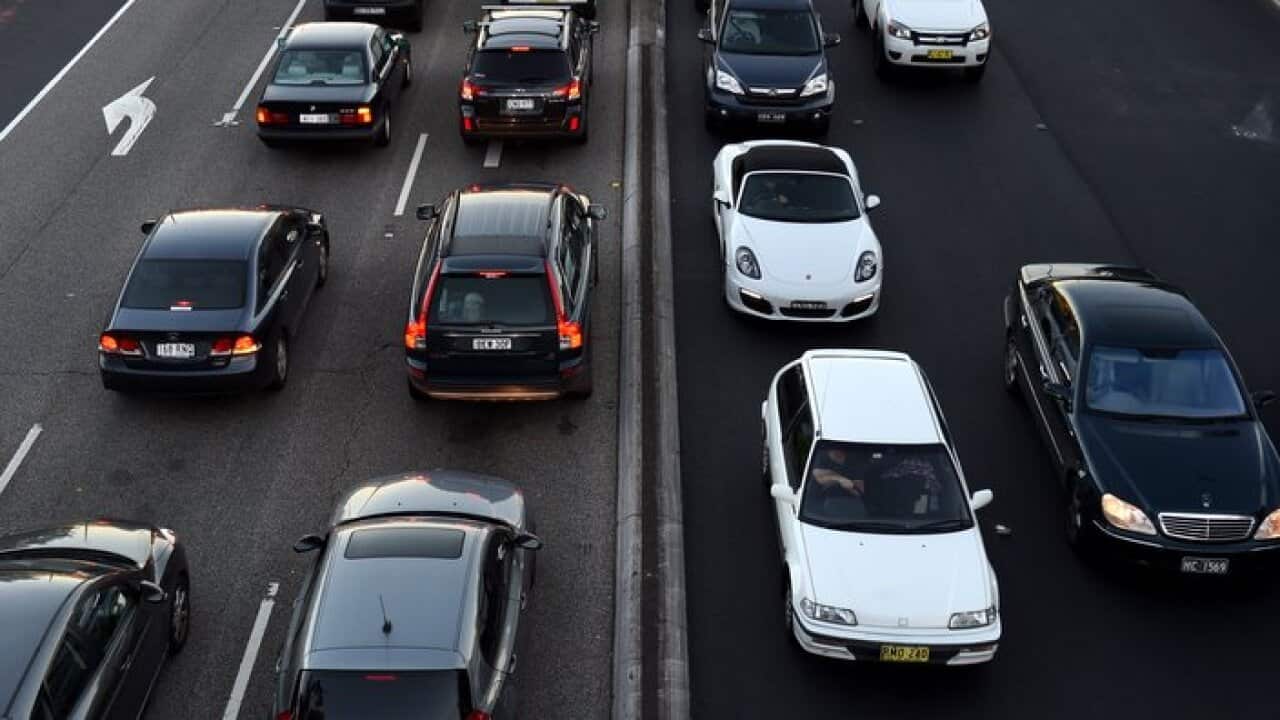 Commuters wait in peak hour traffic in Sydney on Tuesday, May 5, 2015. (AAP Image/Paul Miller) NO ARCHIVING