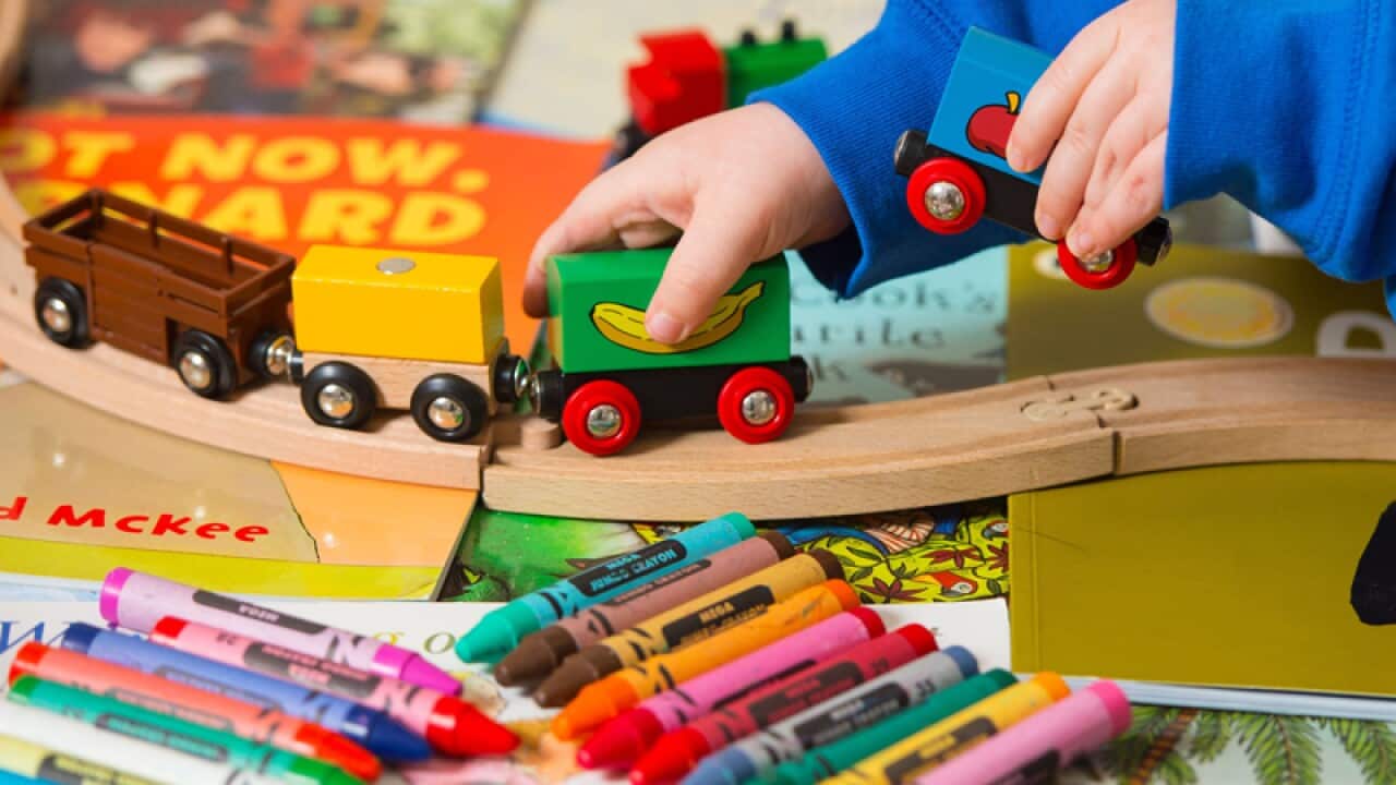 A toddler playing with toys.