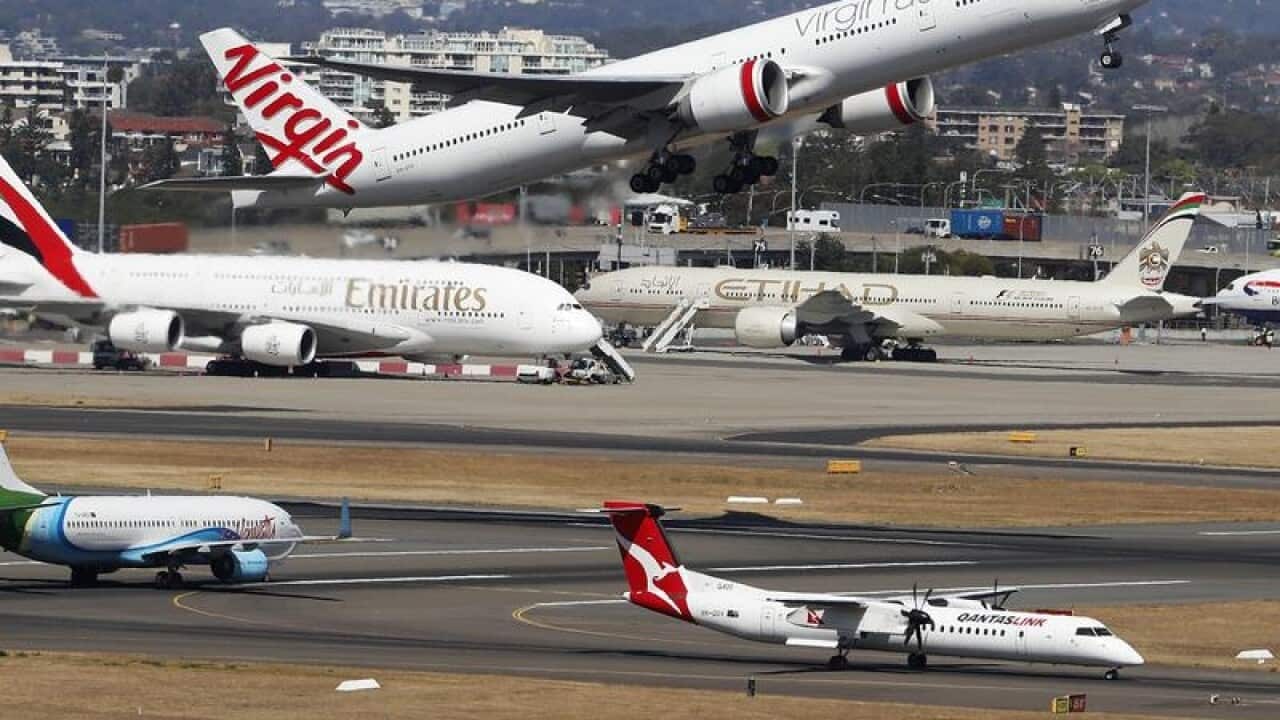 A plane takes off at Sydney Airport.