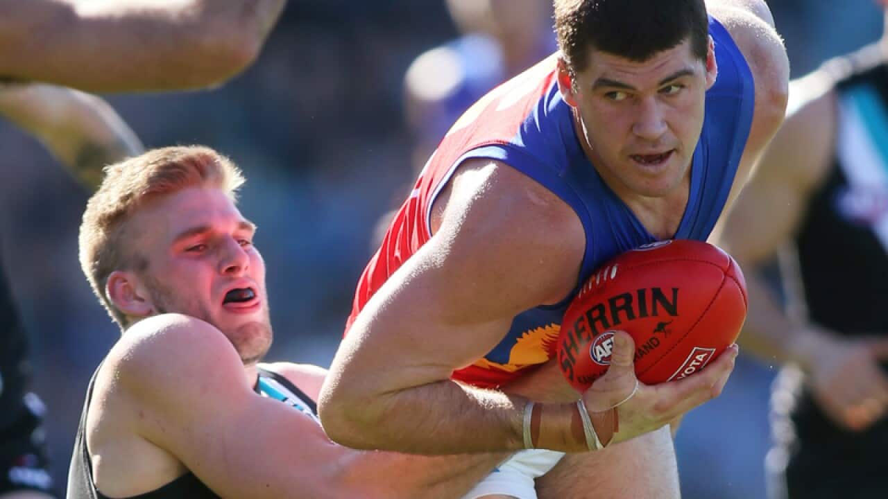 Brisbane Lions forward Jonathan Brown (R) in action