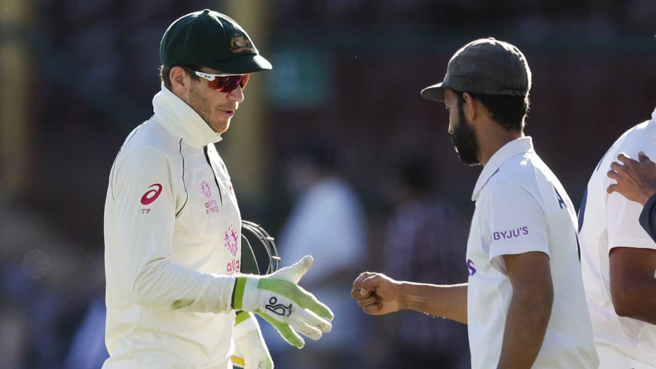 Australia’s Tim Paine and India's Ajinkya Rahane on the final day of cricket