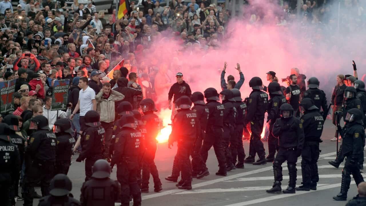 In this Aug 27, 2018 file photo protesters light fireworks during a far-right demonstration in Chemnitz, Germany, after a man died.