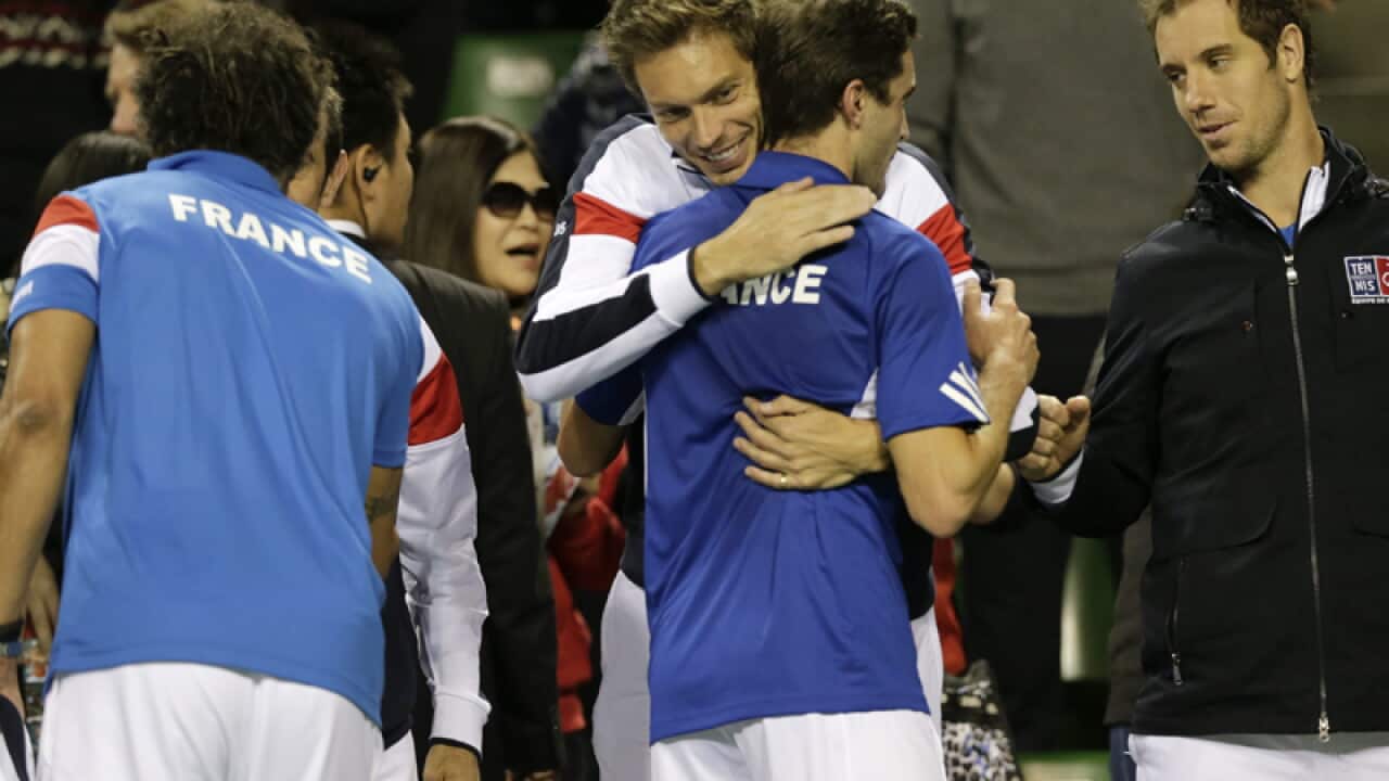 Gilles Simon (C) celebrates after his Davis Cup singles win