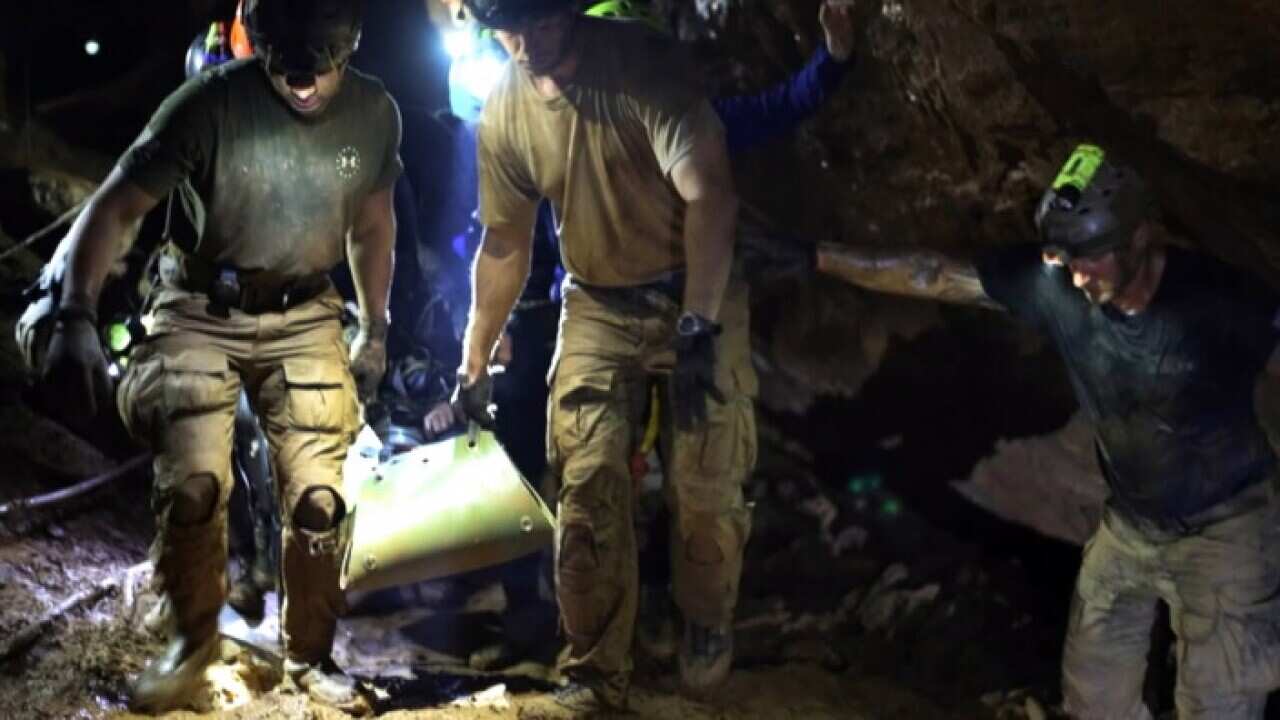 Rescuers carry a boy out of the Thai cave on a stretcher