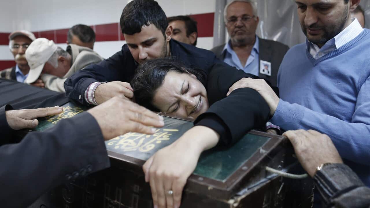 Relatives of Uygar Coskun, who was killed the previous day in a twin blast in Ankara, mourn over his coffin during a funeral ceremony in Ankara, Turkey, 12 October 2015. (EPA/SEDAT SUNA)