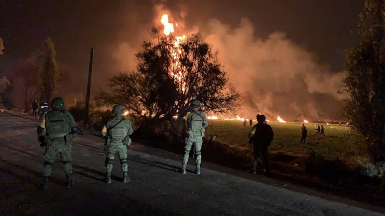 Soldiers guard the area where an explosion killed at least 66 people in Mexico.