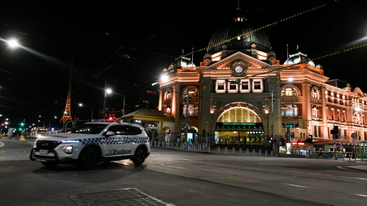 A police car is seen outside Flinders Street Station after a citywide curfew is introduced in Melbourne, Sunday, 2 August, 2020.