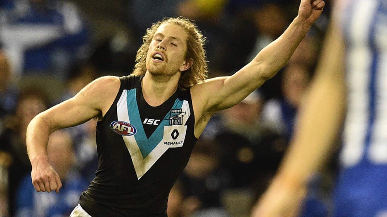 Aaron Young of Port Power reacts after kicking a goal